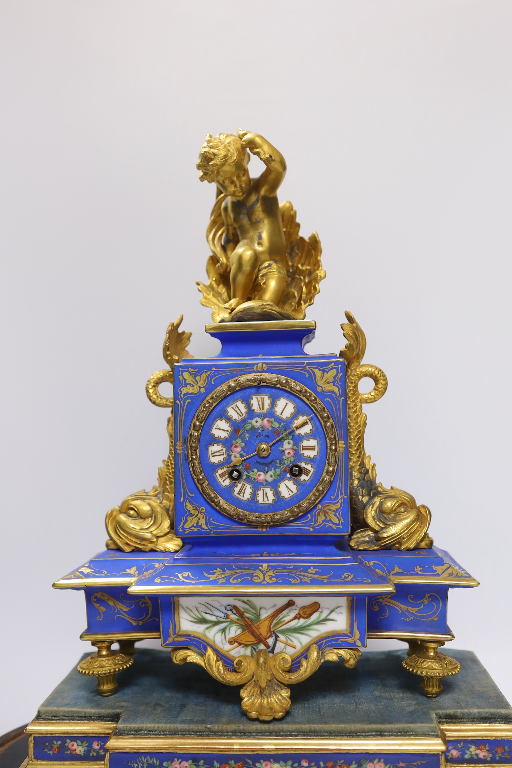 A 19th century French porcelain and gilt mantel clock under glass dome, striking on a bell, the face signed Muller, 48cm high, under dome